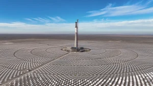A panoramic view of a large solar farm in rural China, with rows of blue photovoltaic panels stretching across open land under clear skies, symbolising the country’s rapid expansion in renewable energy.