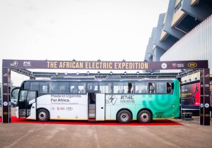 The Kayoola Electric Coach, built by Kiira Motors Corporation, displayed at the launch of the African Electric Expedition under a branded archway reading ‘The African Electric Expedition